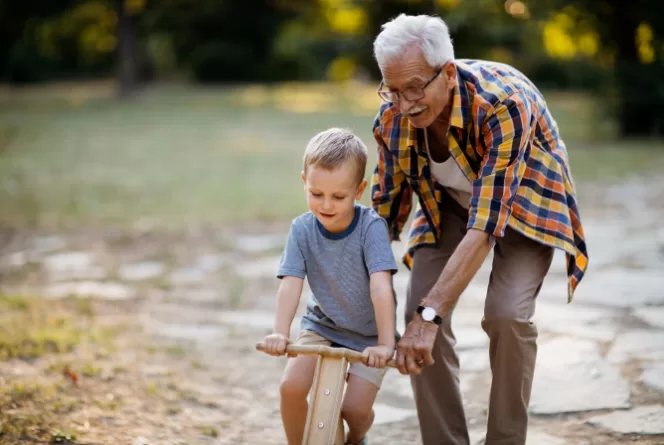abuelo enseñando a su nieto como andar una bicicleta 